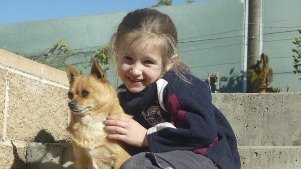 Natasha Mitchell holds family pet Dima.