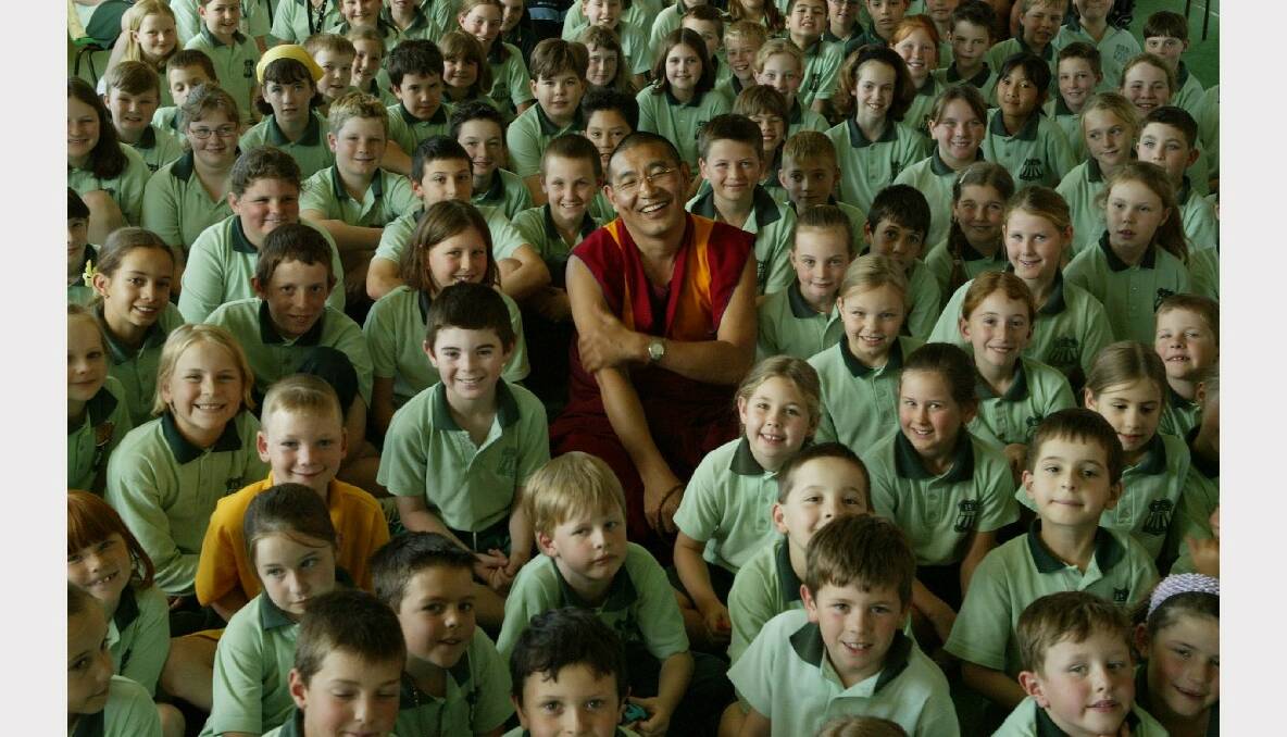 Tibetan monk Geshe Sonam Thargye with students at Mt Ousley Public School after sharing his life story with them.
