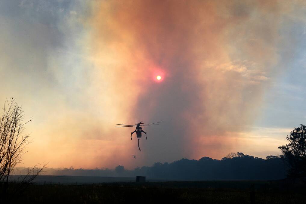 A water bombing helicopter at Yanderra during the October bushfires. Picture: SYLVIA LIBER