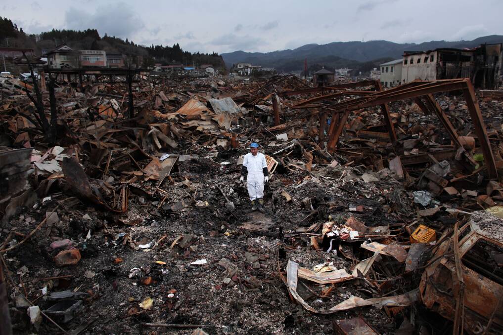 Sigo Hatareyama works to clean out what is left of his house in the aftermath of the 2011 earthquake. 