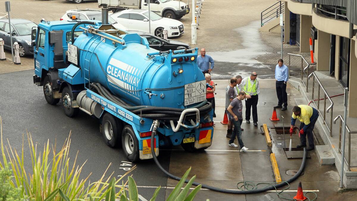 Sydney Water inspectors and contractors near the Fishermen's Co-Op at Wollongong Harbour. Picture: KIRK GILMOUR