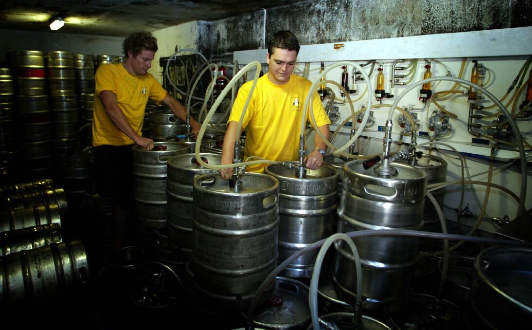 North Gong Hotel workers Jack Van der Glas and Lachlan Bate prepare the kegs for New Year's Eve.