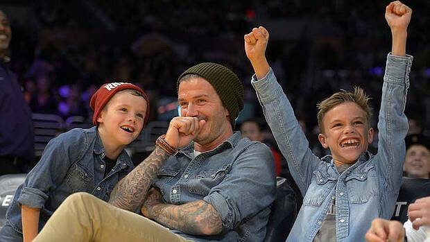 David Beckham shares a laugh with sons Cruz and Romeo. Picture: AP