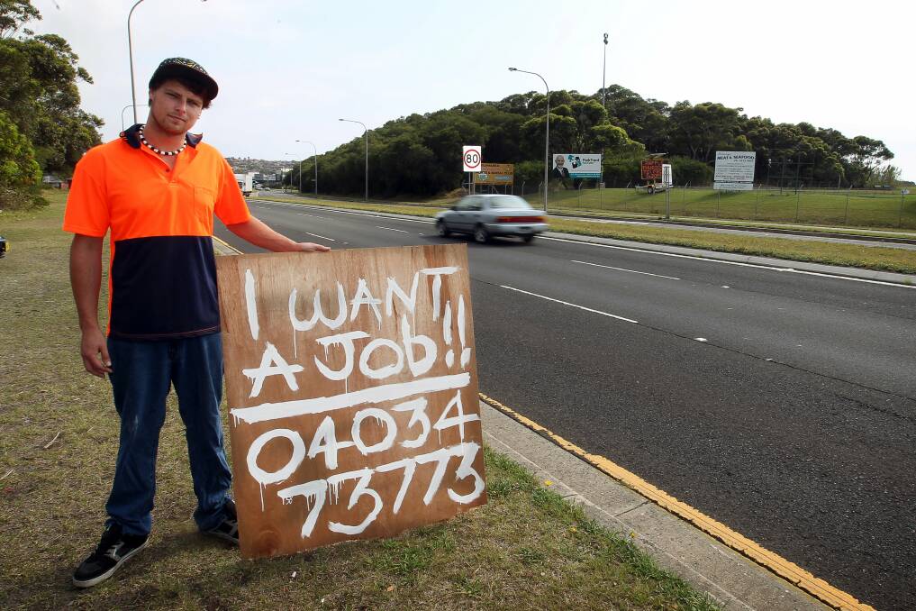 NOVEMBER: Daniel Davey on Windang Road with his sign. Picture: SYLVIA LIBER