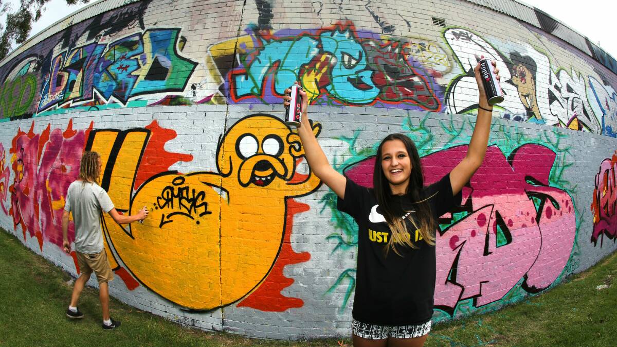 Isabella Tarvij from Wollongong lets fly with the aerosol paint at the Wollongong Youth Centre event. Picture: KIRK GILMOUR