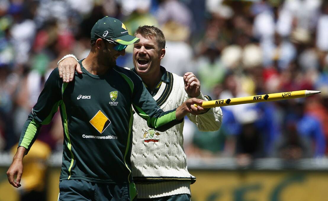 David Warner, right, celebrates with Nathan Lyon after winning the fourth Ashes cricket test against England. Picture: GETTY IMAGES