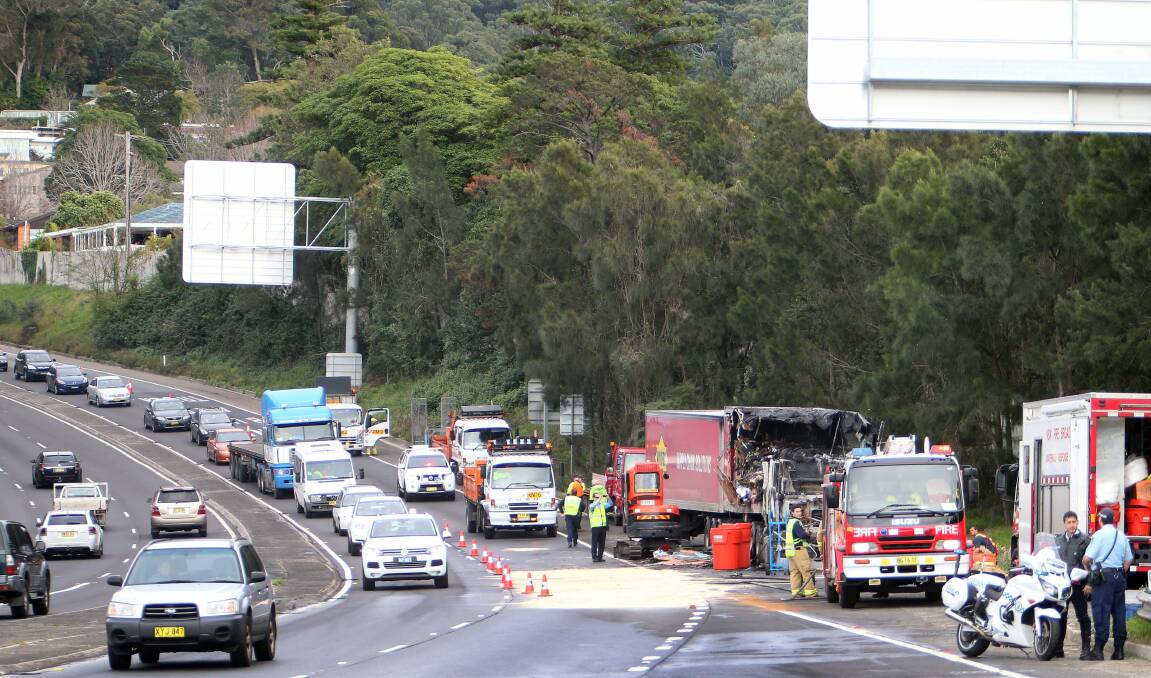 Emergency services begin the clean-up after a B-double truck caught fire at the bottom of Mount Ousley Road last week.
