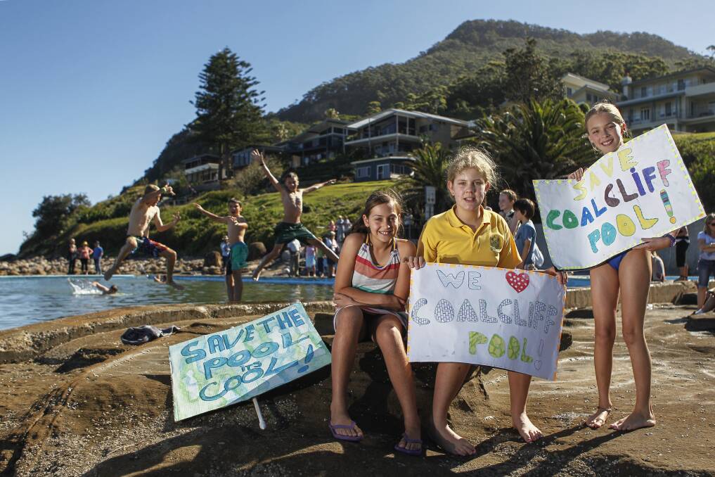 Olivia, 11, Kirra, 12, and Tianna, 10, at Coalcliff pool, protesting in response to an unpopular council proposal. Picture: CHRISTOPHER CHAN