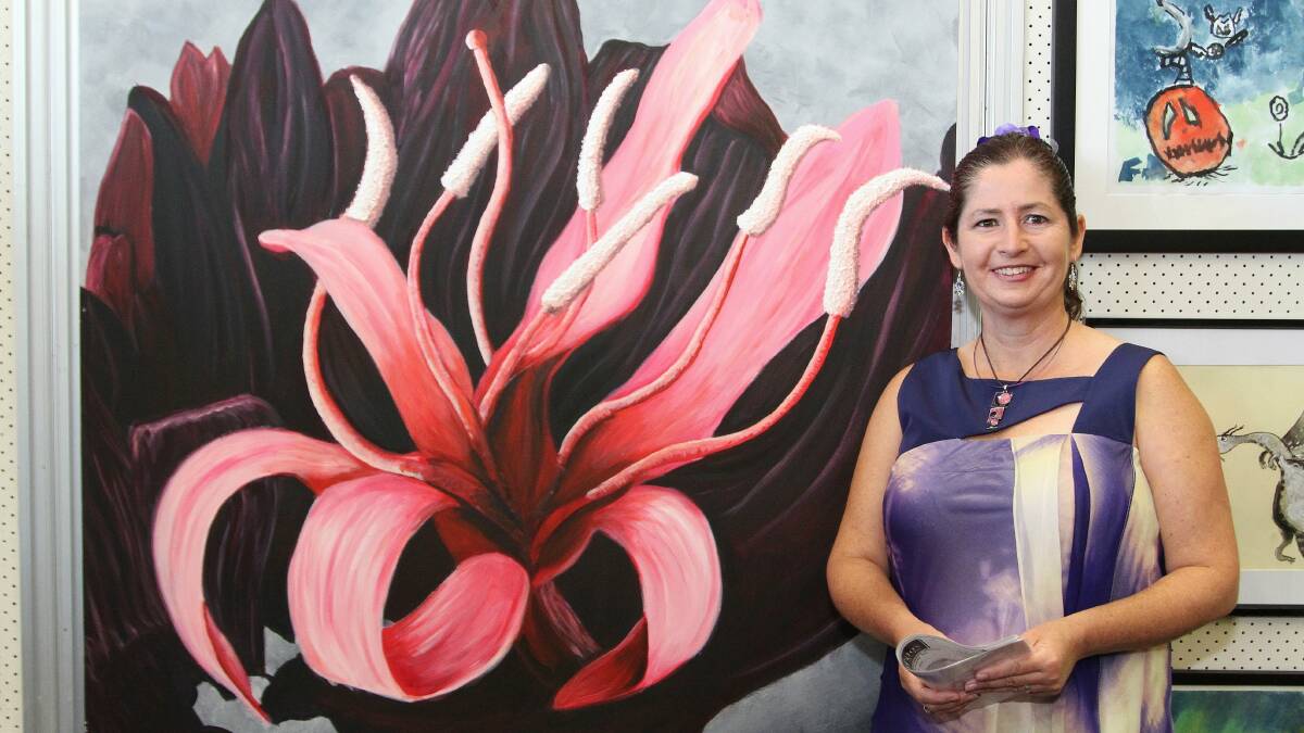 Alison Foley, of Albion Park, with her People’s Choice Award painting called Triffid. Picture: GREG ELLIS