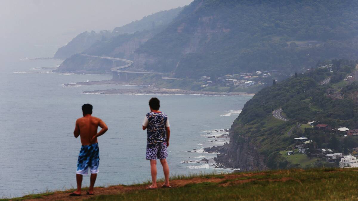 Tourists gaze at thick haze over Bald Hill, Stanwell  Park. Picture: ADAM McLEAN