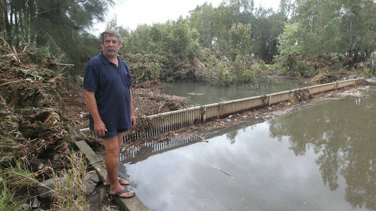 Garry Southwell at the flooded back of his house at Bensons Creek, King Mickey Park. 