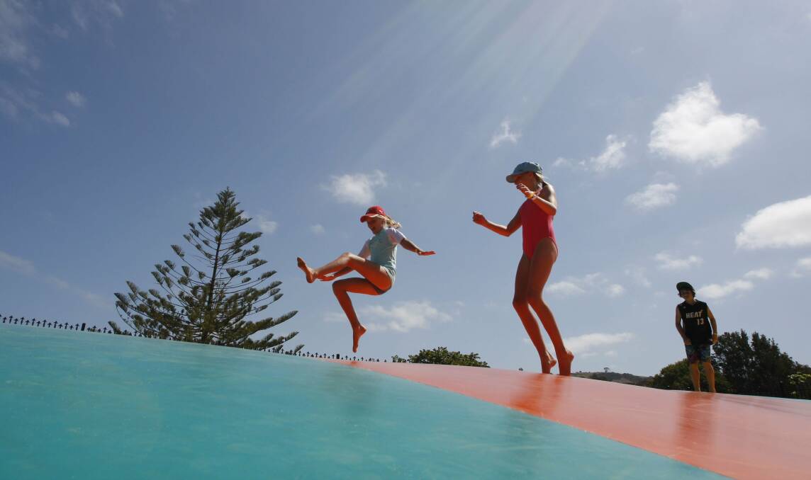 Young holidaymakers enjoy the bouncing pillow at Easts Beach Holiday Park. Picture: ANDY ZAKELI