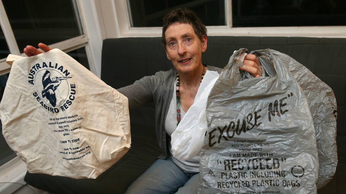 Cr Jill Merrin holds environmentally-friendly plastic bags in her left hand and, in her right, an environmentally-friendly cloth bag. Picture: KIRK GILMOUR