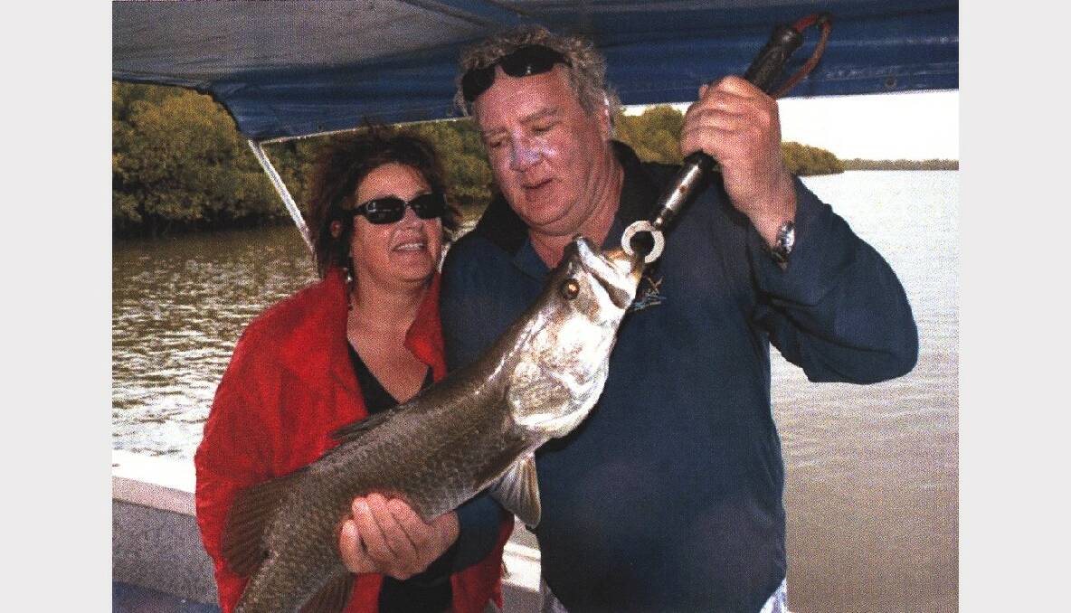 With wife Margaret, indulging in his passion for fishing.