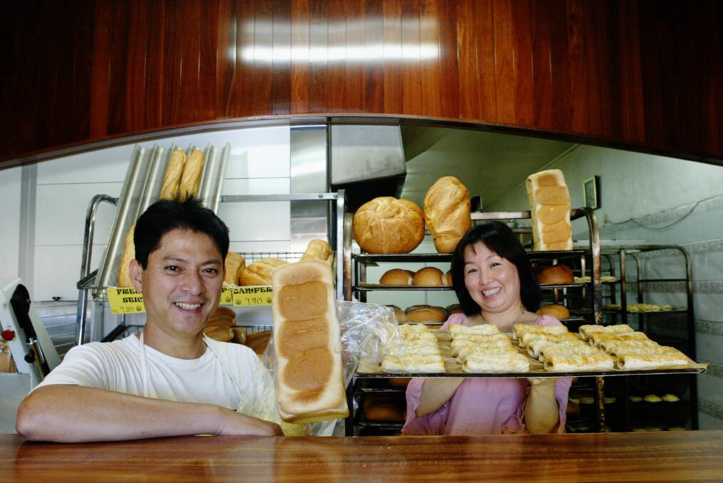 Former refugees Ton and Cuc Vo at Corrimal Bakehouse with some of their award-winning fare.
