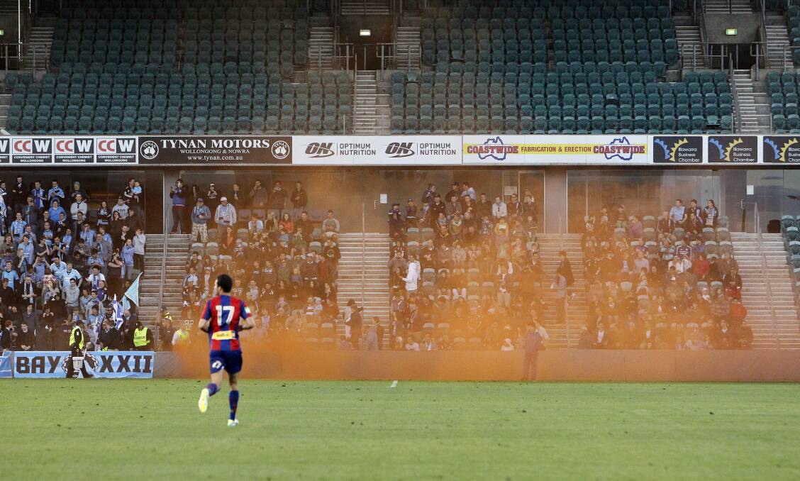 Sydney FC faithful let off a flare before the start of the match against Newcastle Jets. 