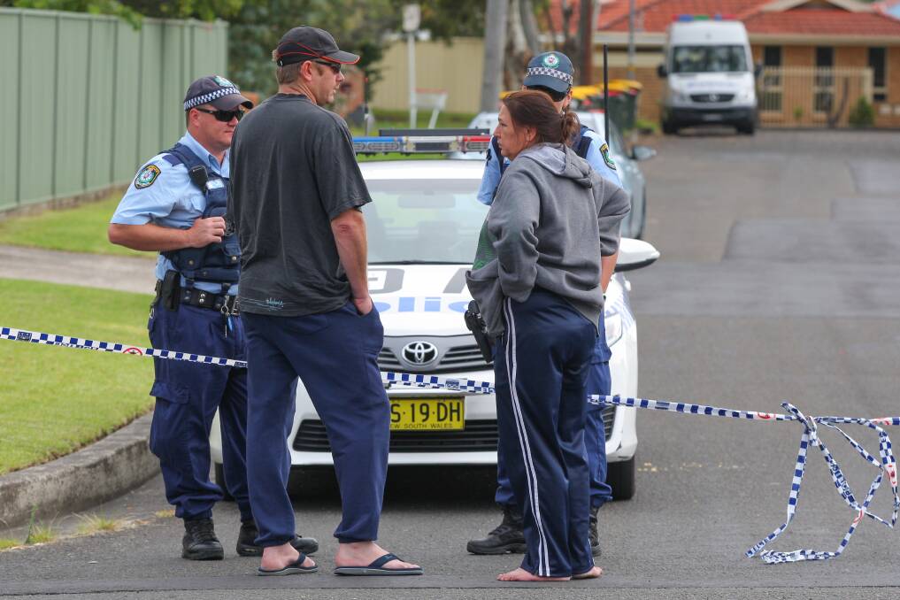 Police speak with neighbours at the scene of the shooting. Picture: ADAM McLEAN