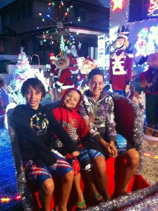 Jett, Boston and Declan in Santa's sleigh. Courtesy Jamie Starcic