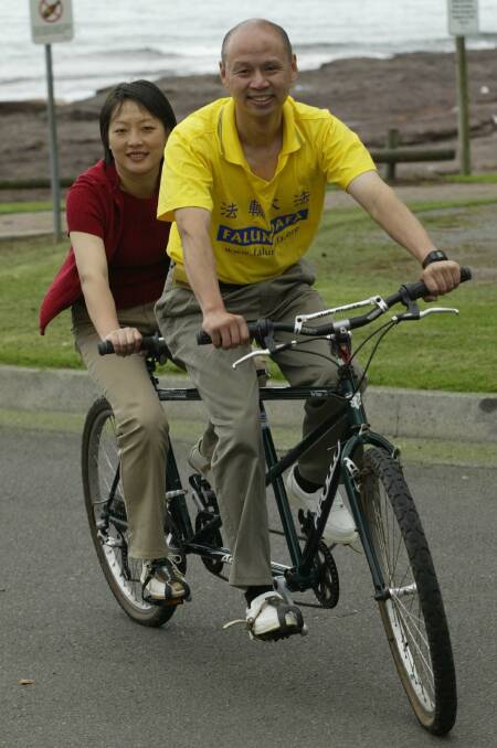 Li Ying rides a bicycle built for two with her fiance Grant Lug.