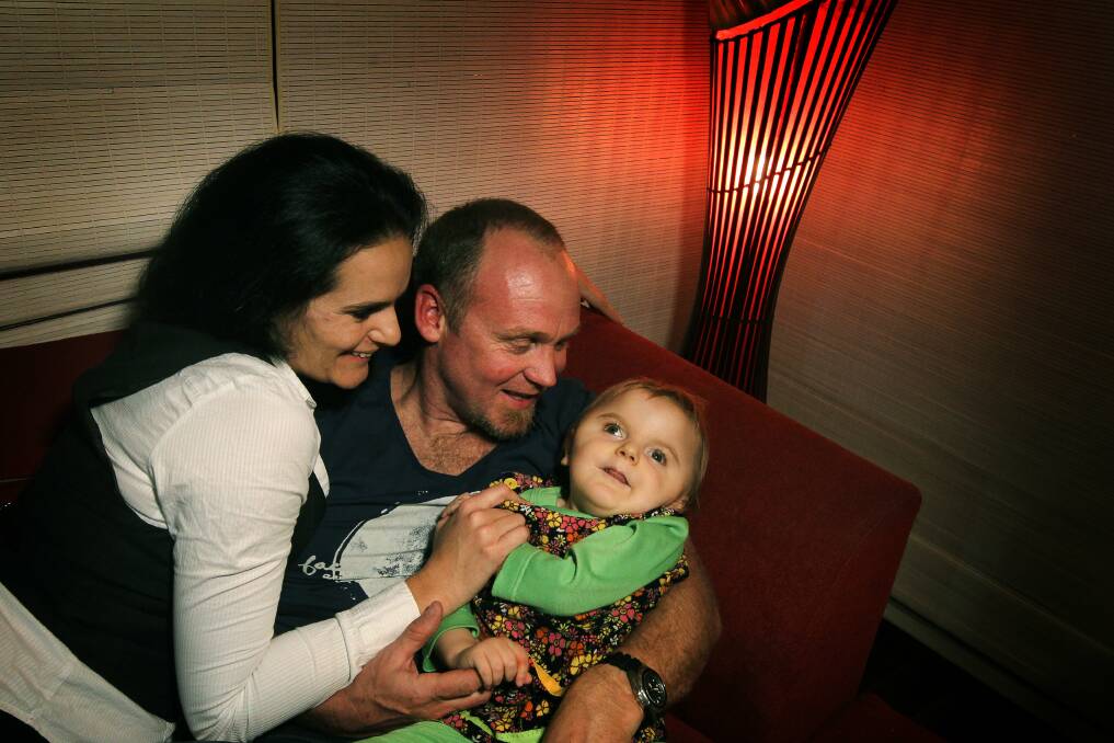 Bella with her mum and dad Michelle and Scott. 