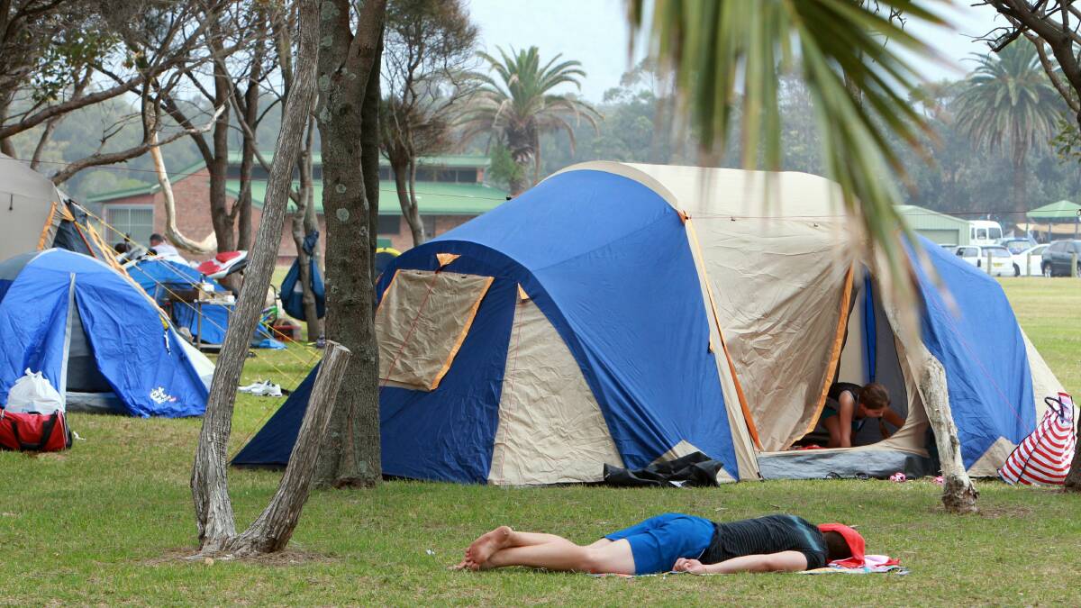 A camper catches up on sleep among camp sites at Stuart Park.