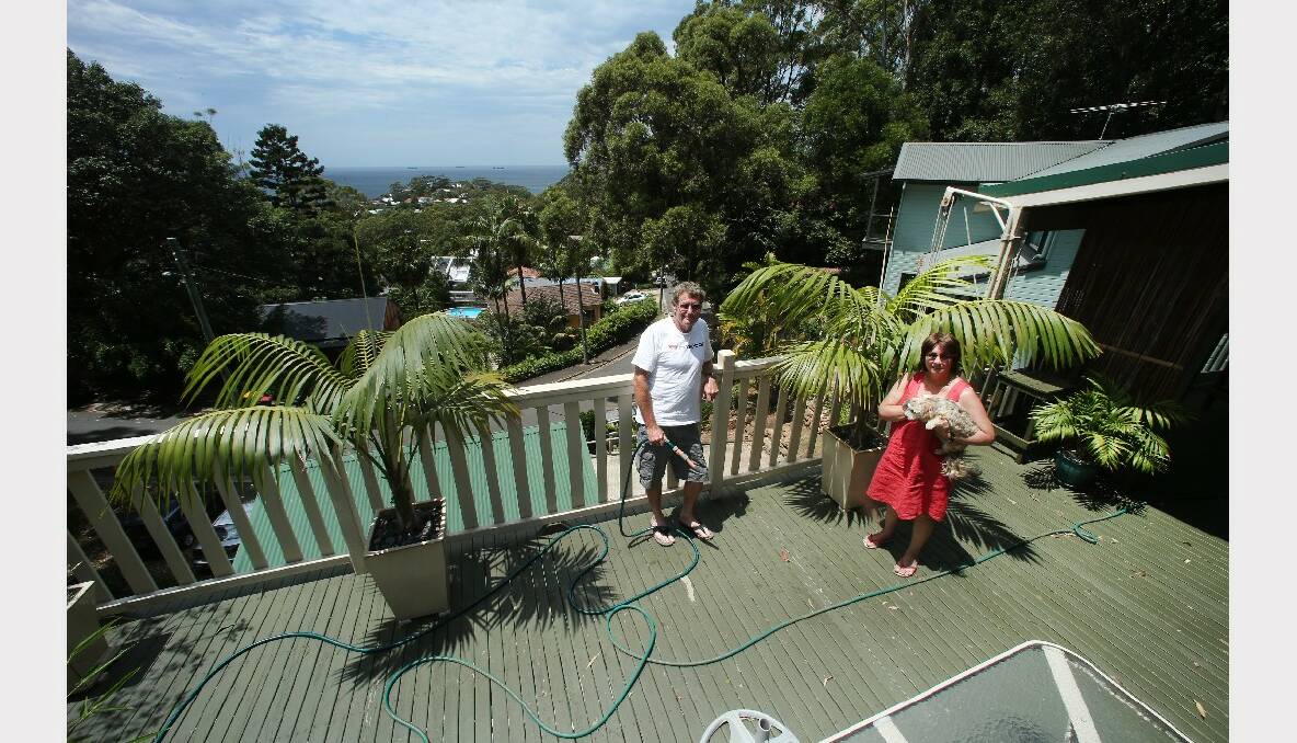 John McCormack and partner Sandra Carbery, with dog Sophie, prepare their Austinmer home for the extreme conditions.