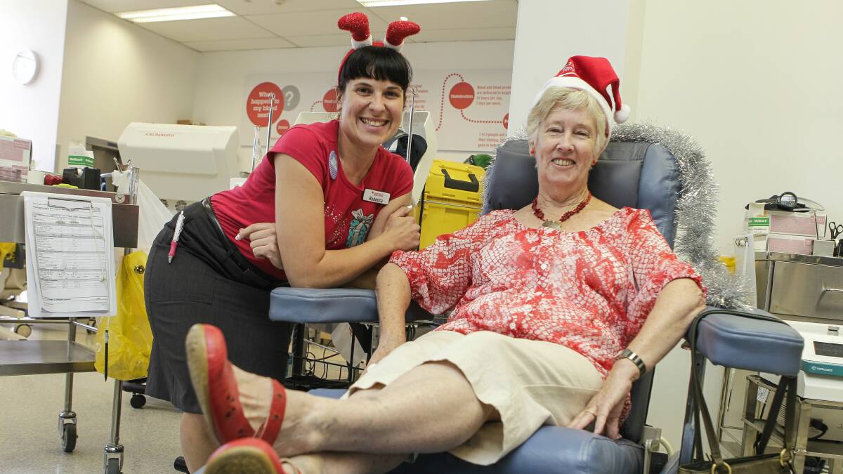 Barbara Street settles back to give her 400th blood donation with the help of nurse Rebecca Furniss. Picture: CHRISTOPHER CHAN