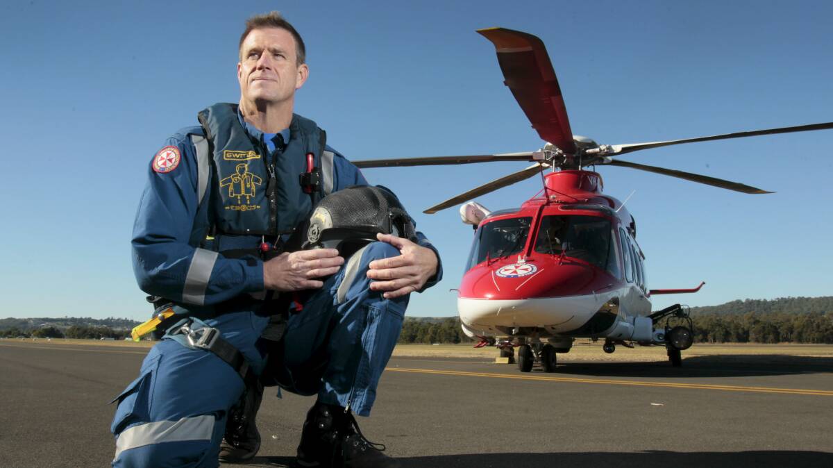 Ambulance officer paramedic Andrew Ryan with the Wollongong-based rescue helicopter. Picture: DAVE TEASE 