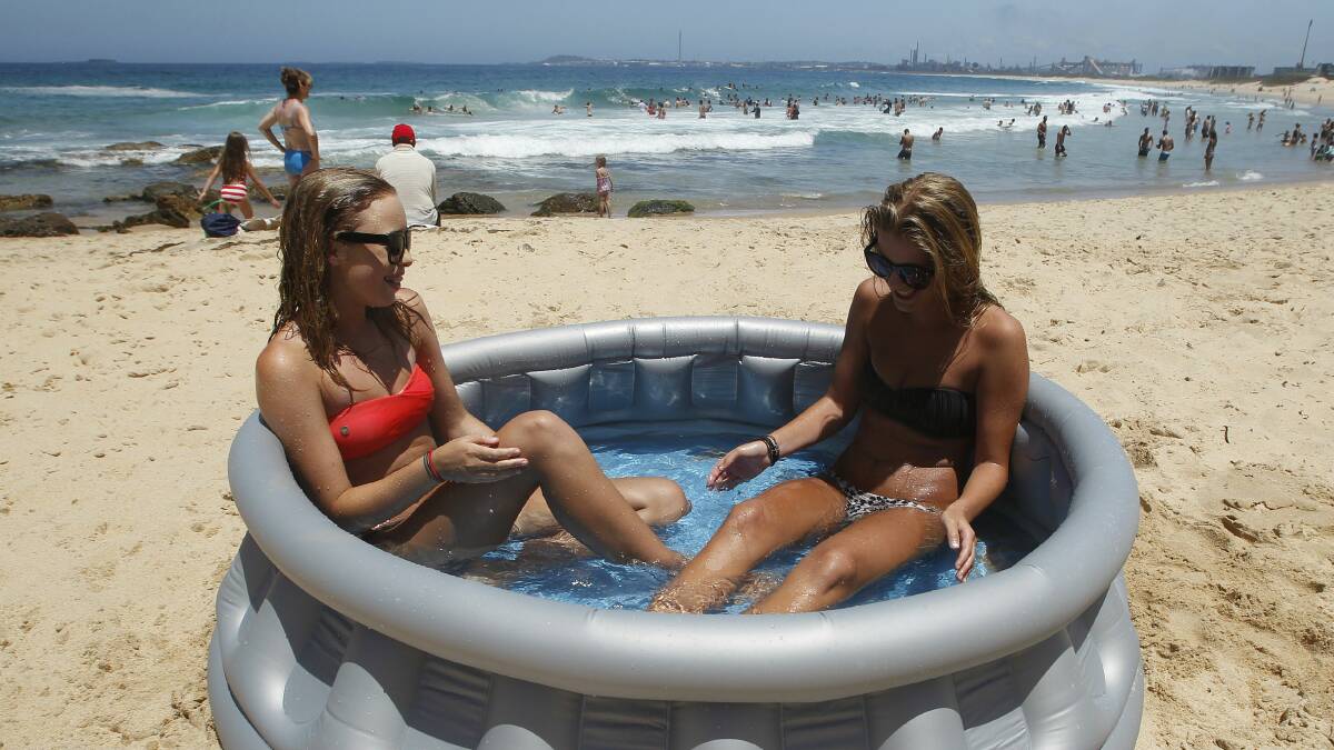Brittany and Dia, both 14, brought an inflatable pool to Wollongong City Beach. Pictures: ANDY ZAKELI