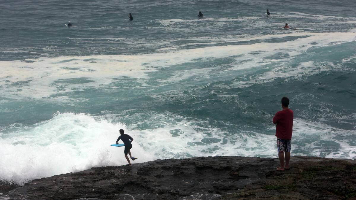 Surfers at South Beach take advantage of the big swells today. Picture: ROBERT PEET