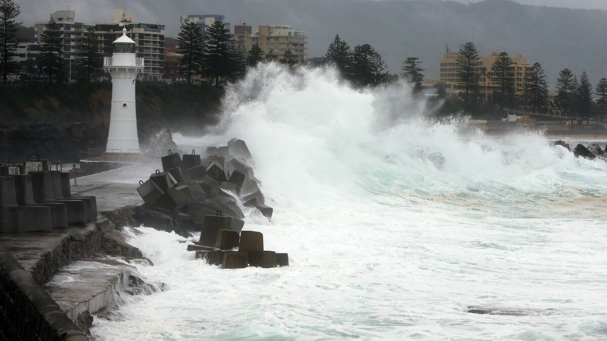 Heavy waves pound the breakwall at Belmore Basin. Picture: ROBERT PEET