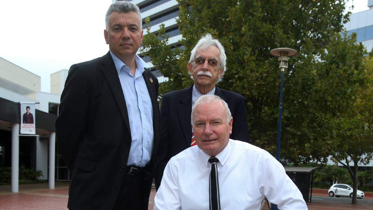 Union official Arthur Rorris, Rotary of Wollongong president Leigh Robinson and Wollongong Lord Mayor Gordon Bradbery are determined to save the aeromedical helicopter. Picture: ROBERT PEET