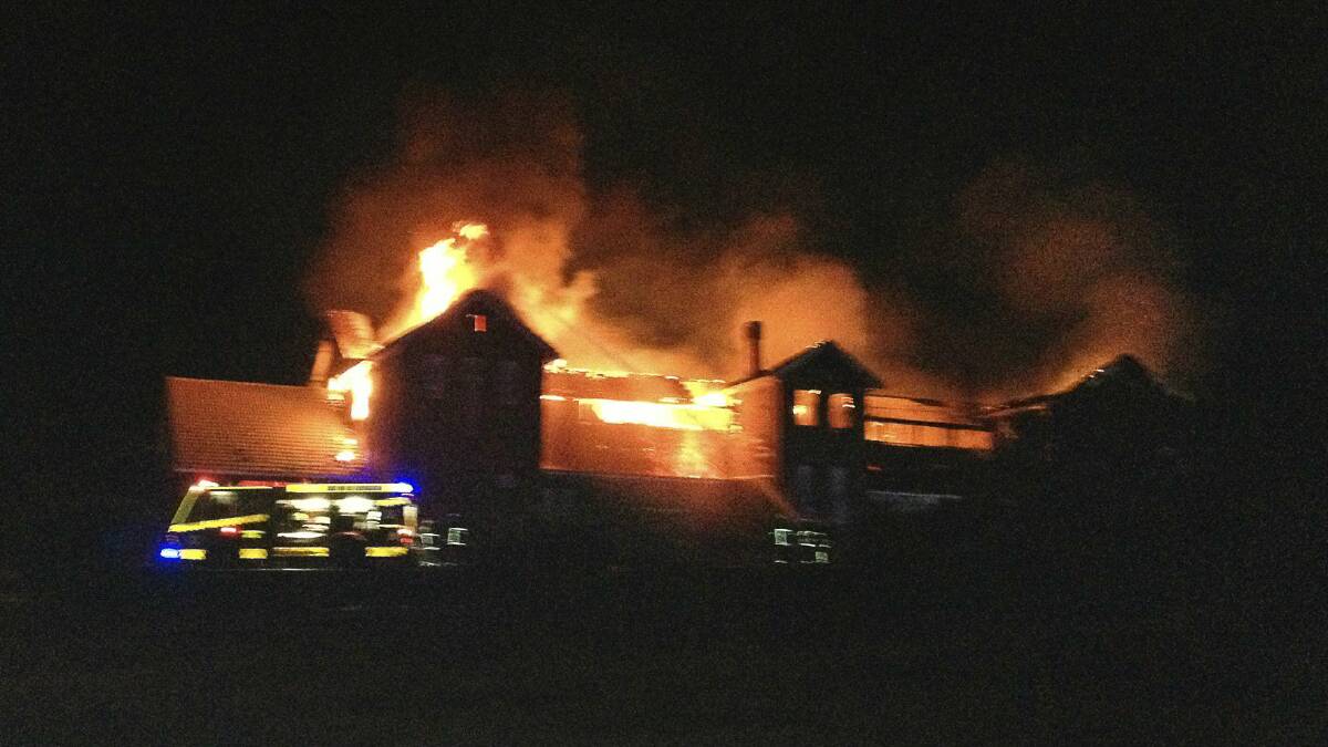 The old Port Kembla Public School ablaze in the early hours of this morning. Picture: LUKE DOERING