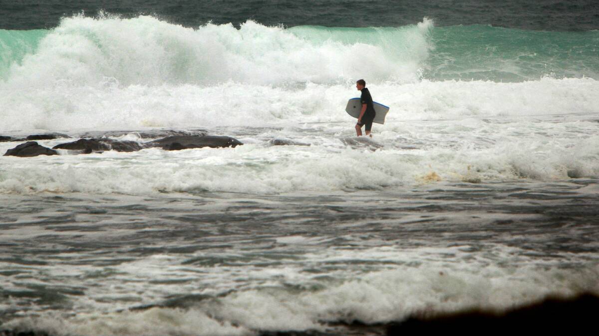 A bodyboarder heads out to catch a wave at Barrack Point. Picture: SYLVIA LIBER