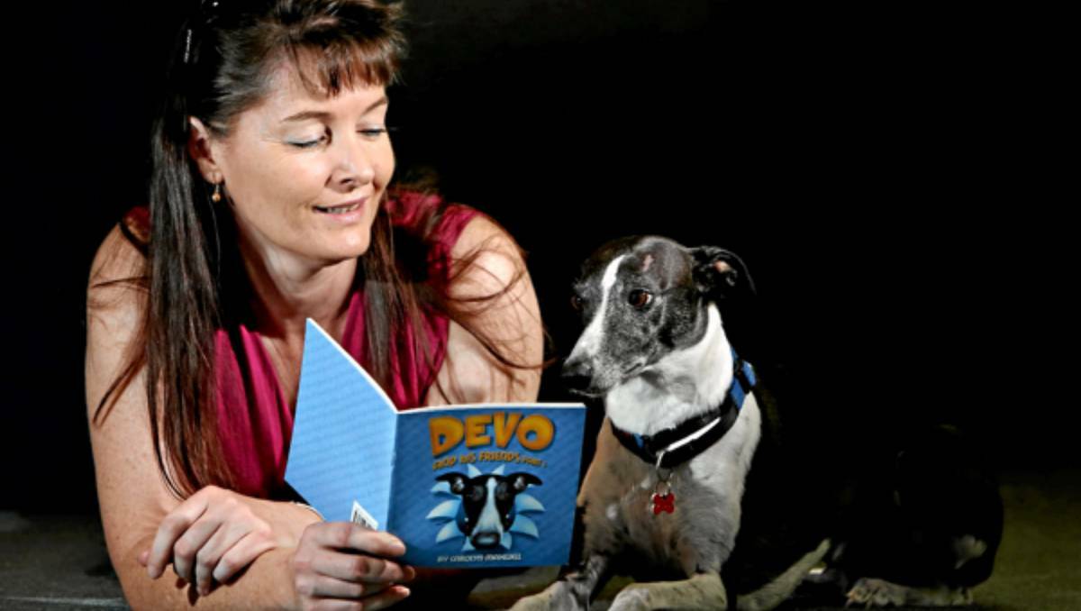 Carolyn Maxwell with the book she wrote about her diabetic alert dog Devo. Picture: KYLIE ESLER