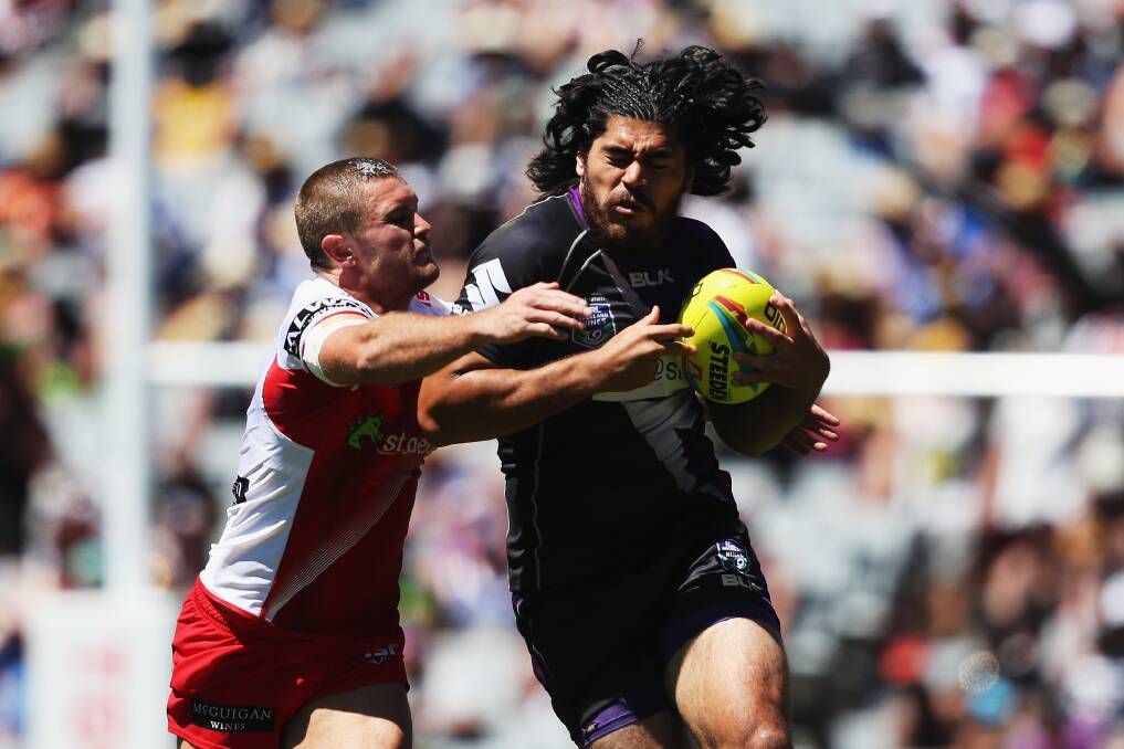 Hanging on: Mitch Rein grapples with Tohu Harris during the Dragons' final day win over Melbourne. Picture: GETTY IMAGES