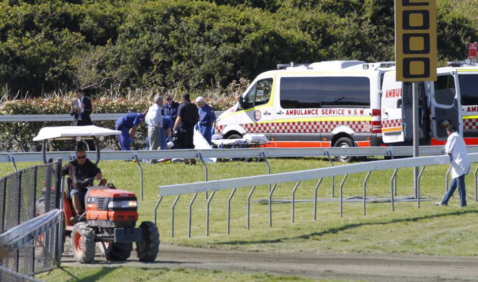 The ambulance attends to the barrier attendant at Kembla Grange on Saturday. Picture: ANDY ZAKELI