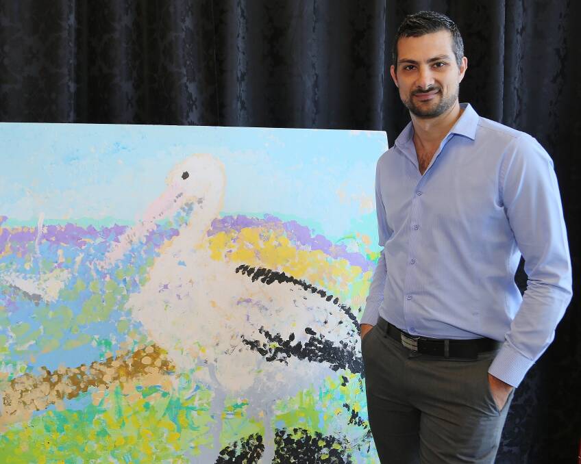 Andrew Harrison, with an artwork completed by children at Little Leonardo's, is inviting adults to try Art by the Lagoon on Tuesday. Picture by Greg Ellis.
