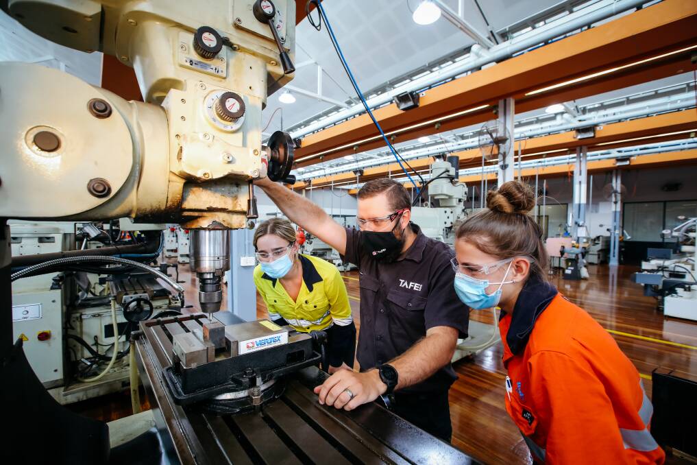 Measure twice: Head teacher mechanical engineering Mathew McGlashan (centre) highlights the precision of the state-of-the-art equipment to Sophia Fish (left) and Alyssa Norris (right). Picture: Wesley Lonergan