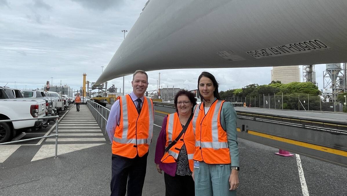Adam Zarth, Wollongong City Council deputy mayor Tania Brown and NSW Ports CEO Marika Calfas with an onshore wind turbine blade shipped through Port Kembla. Picture by Connor Pearce