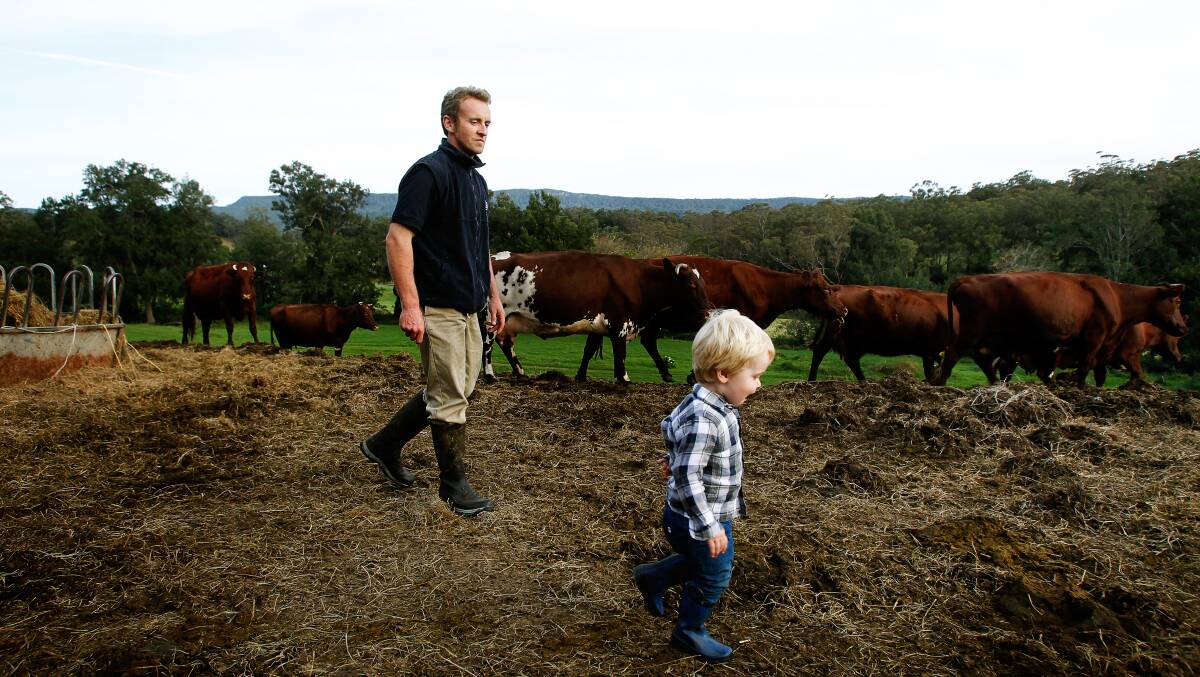 Dairy farmer Steven Downes with son Leo, pictured in 2016. Picture by Sylvia Liber