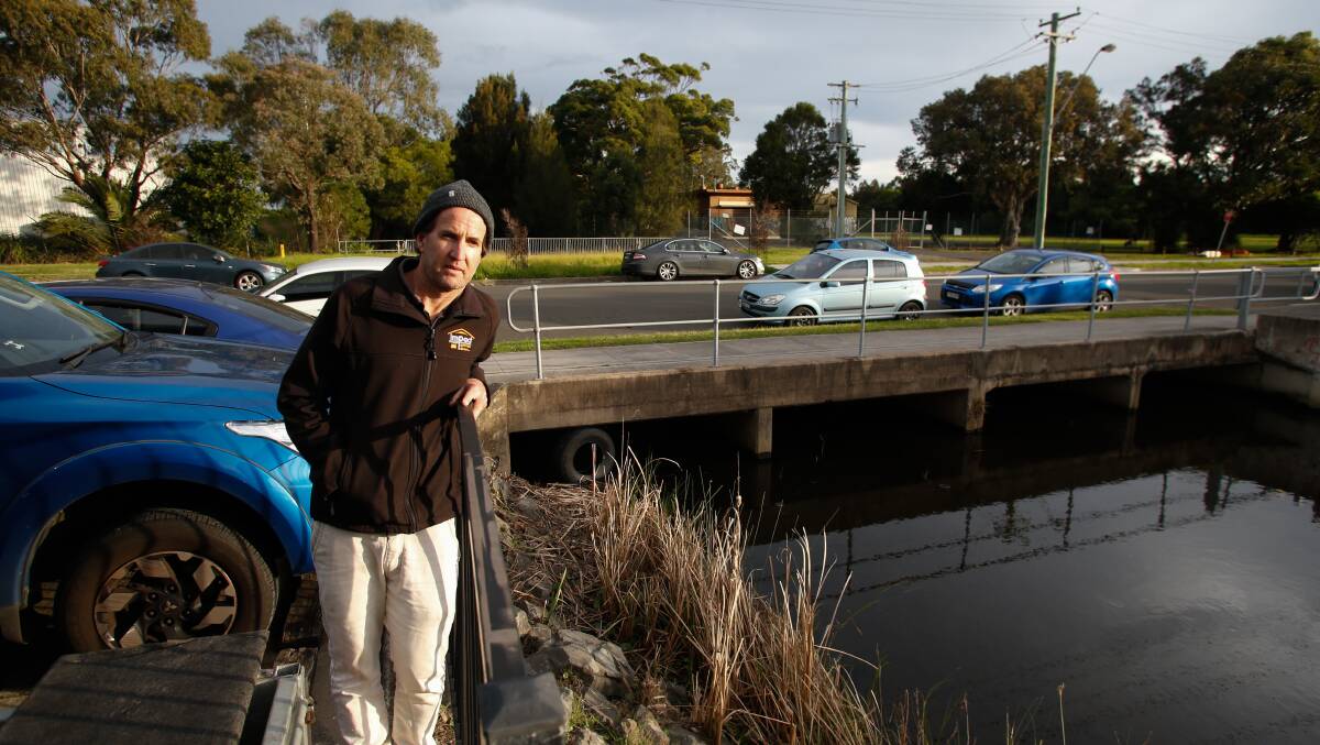 Jamie Adams's business backs on to the Gurungaty Waterway in Wollongong, which flooded in 2022. Picture by Anna Warr