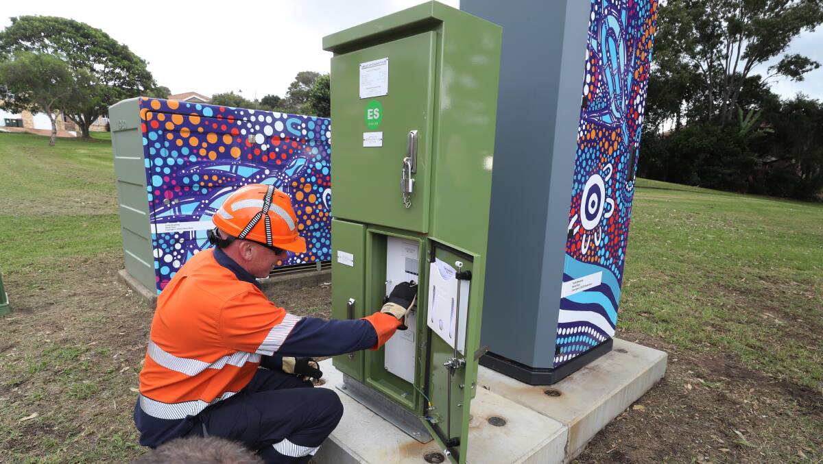 Russell Caddan turns on the battery, which will store and feed in power to around 40 homes. Picture by Robert Peet