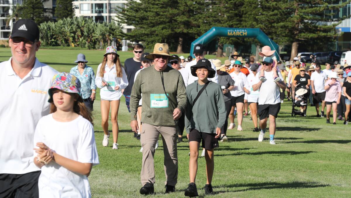 Tony Tate (centre) with son Billy during the Melanoma March. Picture by Robert Peet