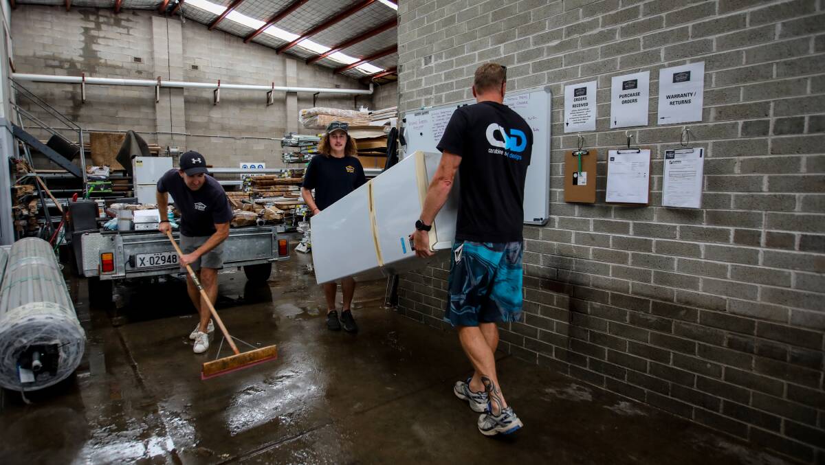 All hands on deck: Staff were called in to clean out after a night of flooding. Picture: Wesley Lonergan
