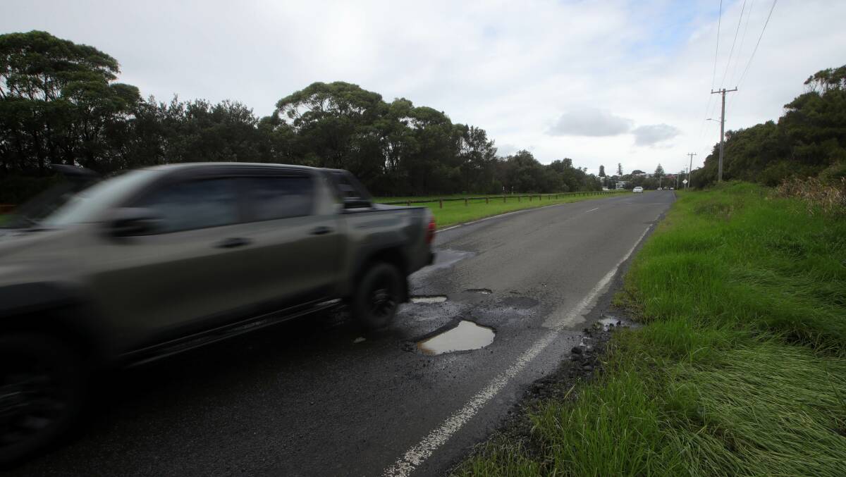 A ute drives past a pothole on Junction Street, Shellharbour. Picture by Sylvia Liber