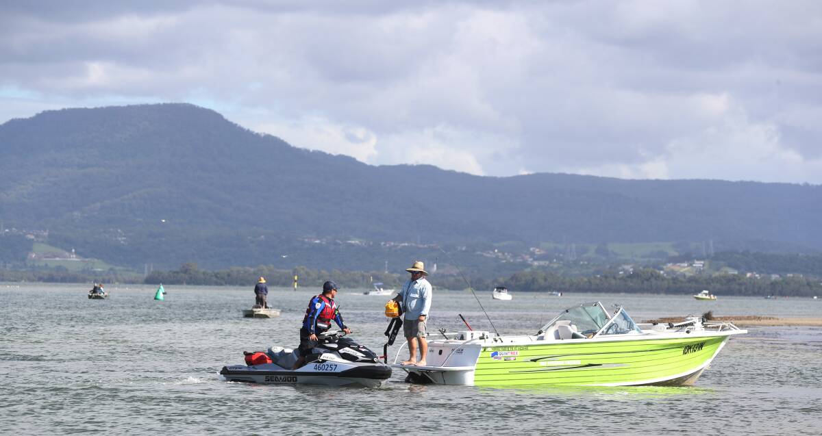 High visibility: Luke Macdonald, NSW Maritime boating safety officer for Wollongong speaks with a boater on Lake Illawarra. Pictures: Robert Peet