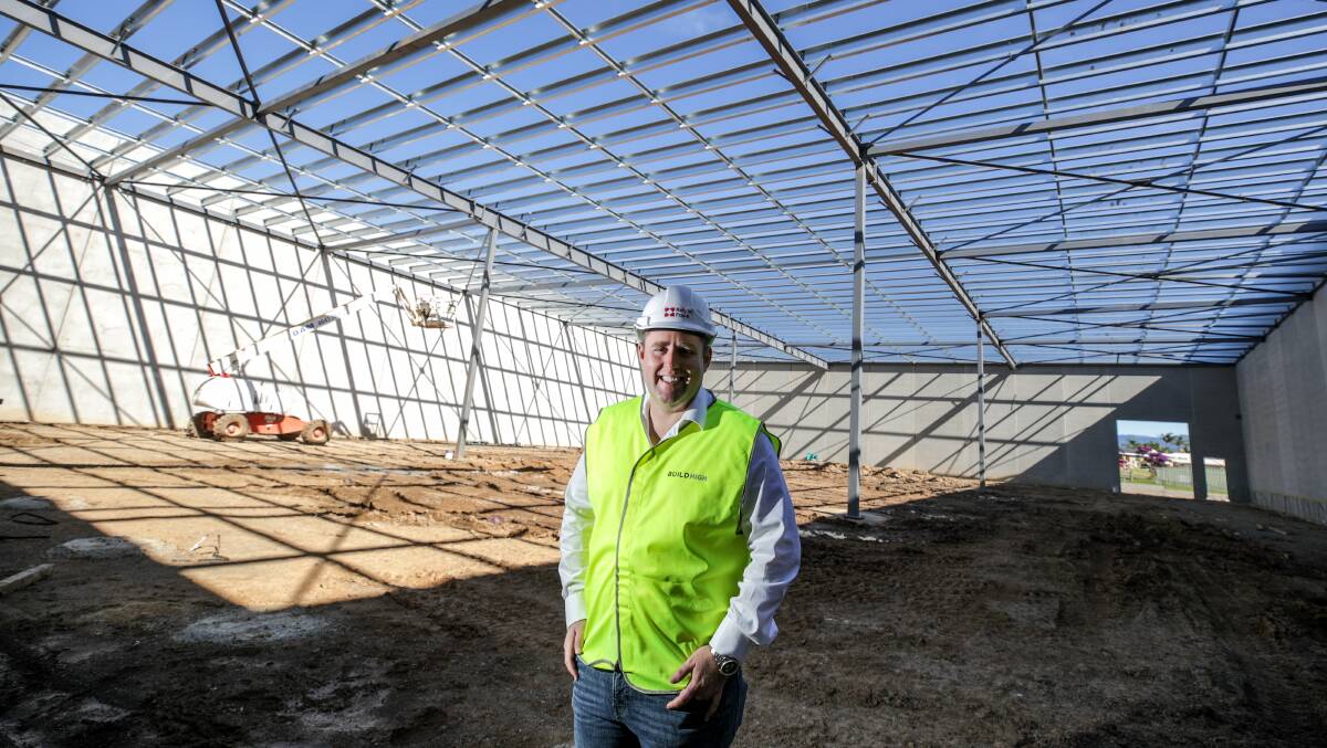 Ben Mostyn stands inside the soon to be completed Officeworks in Albion Park Rail. Picture by Adam McLean