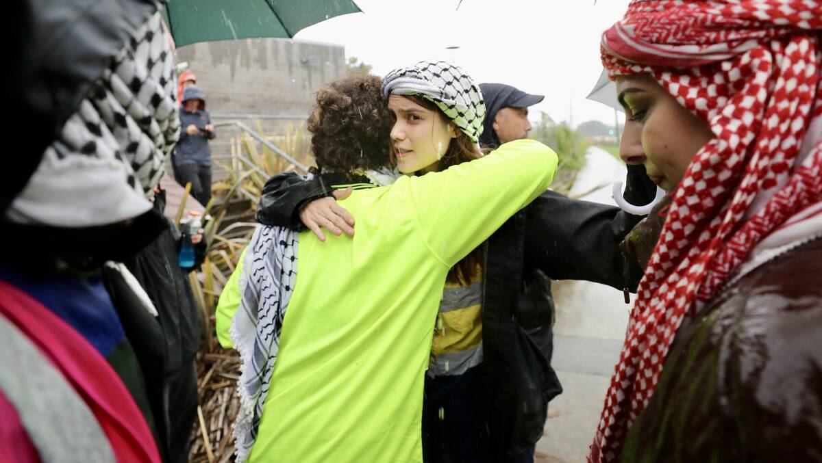 Pro-Palestine protesters embrace after their release from Lake Illawarra police station after being arrested. Picture by Adam McLean