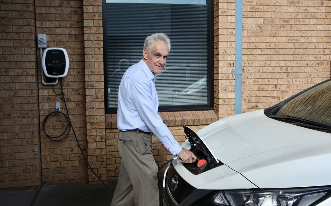 No cost: Jaime Gallinar fills up his Nissan Leaf for free, thanks to solar panels on his business. Picture: Sylvia Liber